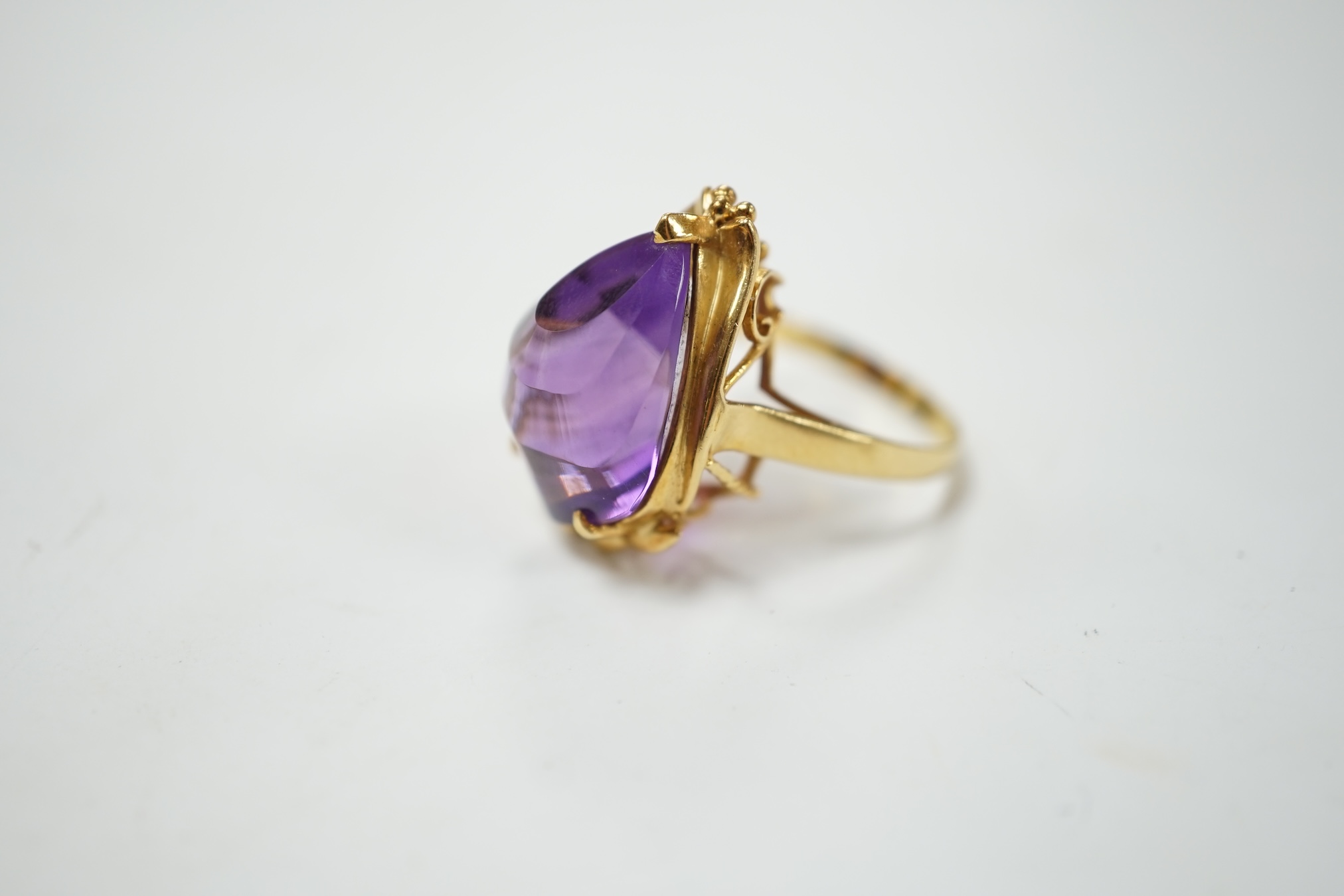 A modern 18k and singe stone fancy pear cut amethyst set dress ring, size L, gross weight 7.1 grams. Condition - good